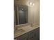 Bathroom featuring a double sink vanity, large mirror, and sleek tiled shower with glass door at 104 Lavender Ln, Clayton, NC 27520