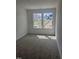 Bright bedroom with a large window offering a view of the neighborhood and plenty of natural light at 104 Lavender Ln, Clayton, NC 27520
