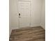 Entryway featuring wood-look flooring and a white paneled front door at 104 Lavender Ln, Clayton, NC 27520