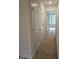 Hallway with carpet and view to a room with a large window at 104 Lavender Ln, Clayton, NC 27520