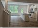 Bright kitchen with white cabinets, granite counters, stainless appliances, and an island with a sink at 104 Lavender Ln, Clayton, NC 27520