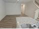 Open concept living space with wood-look floors, ample light, and granite countertop at 104 Lavender Ln, Clayton, NC 27520
