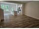 Open concept living area with wood-look flooring and natural light from large windows at 104 Lavender Ln, Clayton, NC 27520