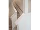 Interior shot of a well-lit staircase with carpeted steps and white banisters and trim at 104 Lavender Ln, Clayton, NC 27520