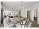 Open-concept dining area with a wooden table, contemporary lighting, and seamless flow to kitchen at 10531 Pleasant Branch Dr # 201, Raleigh, NC 27614