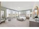 Bright main bedroom with sitting area, neutral decor, carpeted floor, and large windows at 10531 Pleasant Branch Dr # 201, Raleigh, NC 27614
