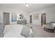 Bright primary bedroom features a sitting area, light gray decor, and multiple entryways at 10533 Pleasant Branch Dr # 201, Raleigh, NC 27614