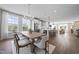 Bright and airy dining room with modern lighting and an open view to the kitchen and living areas at 10533 Pleasant Branch Dr # 201, Raleigh, NC 27614