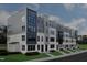 Modern townhome complex with mixed materials and neutral color palette on a well maintained lawn at 10533 Pleasant Branch Dr # 201, Raleigh, NC 27614