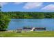 Scenic lake with a pier, surrounded by lush greenery; a peaceful waterside retreat at 10533 Pleasant Branch Dr # 201, Raleigh, NC 27614