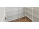 Spacious walk-in pantry with wire shelving and wood-look flooring, providing ample storage at 10533 Pleasant Branch Dr # 201, Raleigh, NC 27614