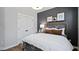 Stylish bedroom showcasing a modern design with dark accent wall, comfortable bed, and ample closet space at 10624 Pleasant Branch Dr # 7, Raleigh, NC 27614