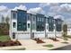 Modern townhome exteriors showcasing three-story facade and individual garages at 10624 Pleasant Branch Dr # 7, Raleigh, NC 27614