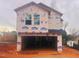 Two-story home under construction features a spacious two-car garage and a modern design at 110 W Kitchin St, Burlington, NC 27215