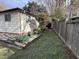 Side yard featuring green ground cover, raised flowerbed, and wood fencing offering a private outdoor space at 1118 W Cornwallis Rd, Durham, NC 27705