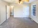A bright bedroom features neutral paint, carpet, a ceiling fan, and a window for natural light at 1125 Field Meadows Dr, Zebulon, NC 27597