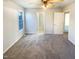 A bright bedroom features neutral paint, carpet, and a window for natural light at 1125 Field Meadows Dr, Zebulon, NC 27597