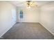 A bright bedroom features neutral paint, carpet, a ceiling fan, and a window for natural light at 1125 Field Meadows Dr, Zebulon, NC 27597