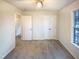 This home has a carpeted bedroom with neutral-colored walls, large windows and closet at 1125 Field Meadows Dr, Zebulon, NC 27597