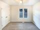 Cozy bedroom featuring a window letting in natural light, soft carpeting, and closet at 1125 Field Meadows Dr, Zebulon, NC 27597