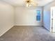 A bright bedroom features neutral paint, carpet, and a window for natural light at 1125 Field Meadows Dr, Zebulon, NC 27597