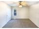 A bright bedroom features neutral paint, carpet, a ceiling fan, and a window for natural light at 1125 Field Meadows Dr, Zebulon, NC 27597
