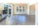 A bright dining room features tile flooring, a chandelier, and access to the back yard at 1125 Field Meadows Dr, Zebulon, NC 27597