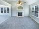 Bright living room with a fireplace and large windows offering plenty of natural light at 1125 Field Meadows Dr, Zebulon, NC 27597