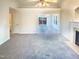 A spacious living room with neutral walls, carpet, fireplace, and an open layout at 1125 Field Meadows Dr, Zebulon, NC 27597