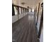 Long hallway featuring wood floors, ceiling lights, windows and light-colored walls at 122 Tomahawk Dr, Louisburg, NC 27549