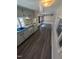 Interior view of the kitchen with an oven, sink, cabinets, and wood floors, with natural light coming from windows at 122 Tomahawk Dr, Louisburg, NC 27549
