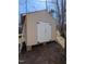 Exterior view of tan wood shed with white doors, sitting on concrete blocks with ladder on side at 122 Tomahawk Dr, Louisburg, NC 27549