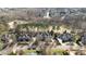 An aerial view of neighborhood houses with manicured lawns, mature trees, and a golf course at 12417 Richmond Run Dr, Raleigh, NC 27614