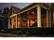 Relaxing screened porch featuring brick fireplace, outdoor tv and comfortable seating at 12417 Richmond Run Dr, Raleigh, NC 27614
