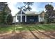 View of the expansive backyard, screened-in porch, and lush landscaping at 12417 Richmond Run Dr, Raleigh, NC 27614