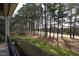 Beautiful backyard view of the golf course and tall trees from the screened porch at 12417 Richmond Run Dr, Raleigh, NC 27614