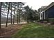 Manicured lawn bordering the golf course and mature trees at 12417 Richmond Run Dr, Raleigh, NC 27614