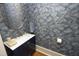 Stylish powder room features faux marble wall treatment, gold hardware, and oval mirror at 12417 Richmond Run Dr, Raleigh, NC 27614