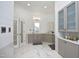 Bright bathroom features double vanity with gray cabinets, marble floors, and shiplap walls at 12417 Richmond Run Dr, Raleigh, NC 27614