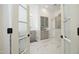 Bathroom with marble floors, soaking tub, and updated fixtures viewed through glass doors at 12417 Richmond Run Dr, Raleigh, NC 27614