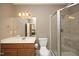 Bathroom with a glass enclosed shower and traditional vanity with storage space at 12417 Richmond Run Dr, Raleigh, NC 27614