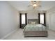 This bedroom has a ceiling fan, neutral paint and carpet, and large windows at 12417 Richmond Run Dr, Raleigh, NC 27614