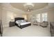 Spacious bedroom boasts trey ceiling, plantation shutters, and neutral color scheme at 12417 Richmond Run Dr, Raleigh, NC 27614