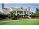 An exterior view of clubhouse with manicured lawn and flowering bushes at 12417 Richmond Run Dr, Raleigh, NC 27614