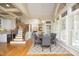 Bright dining room features a staircase, large windows, and an elegant chandelier at 12417 Richmond Run Dr, Raleigh, NC 27614