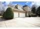 Two-story brick home featuring an attached three car garage and paved driveway at 12417 Richmond Run Dr, Raleigh, NC 27614