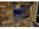 Modern linear fireplace set in a stone wall on an outdoor covered patio at 12417 Richmond Run Dr, Raleigh, NC 27614