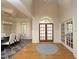 Elegant foyer features hardwood floors, an arched doorway, and stylish double doors that lead into other rooms at 12417 Richmond Run Dr, Raleigh, NC 27614