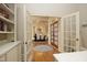 Through the foyer, the dining room is visible with hardwood floors, an arched doorway, and stylish double doors at 12417 Richmond Run Dr, Raleigh, NC 27614