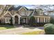 A beautiful two-story brick home with stone accents, a welcoming front porch, and manicured landscaping at 12417 Richmond Run Dr, Raleigh, NC 27614